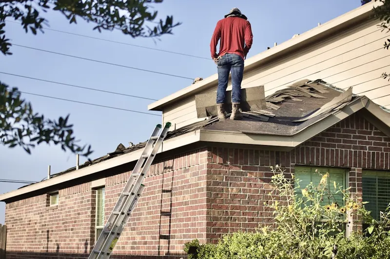 Professional roofer working on a residential roof in Takoma